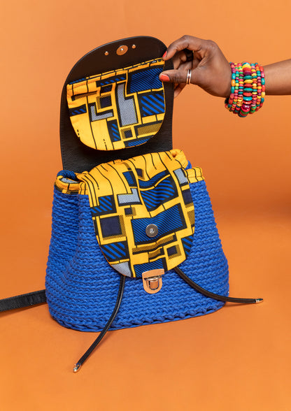 crocheted, blue and black bag, with an African style, orange print. Opened, showing compartments. 