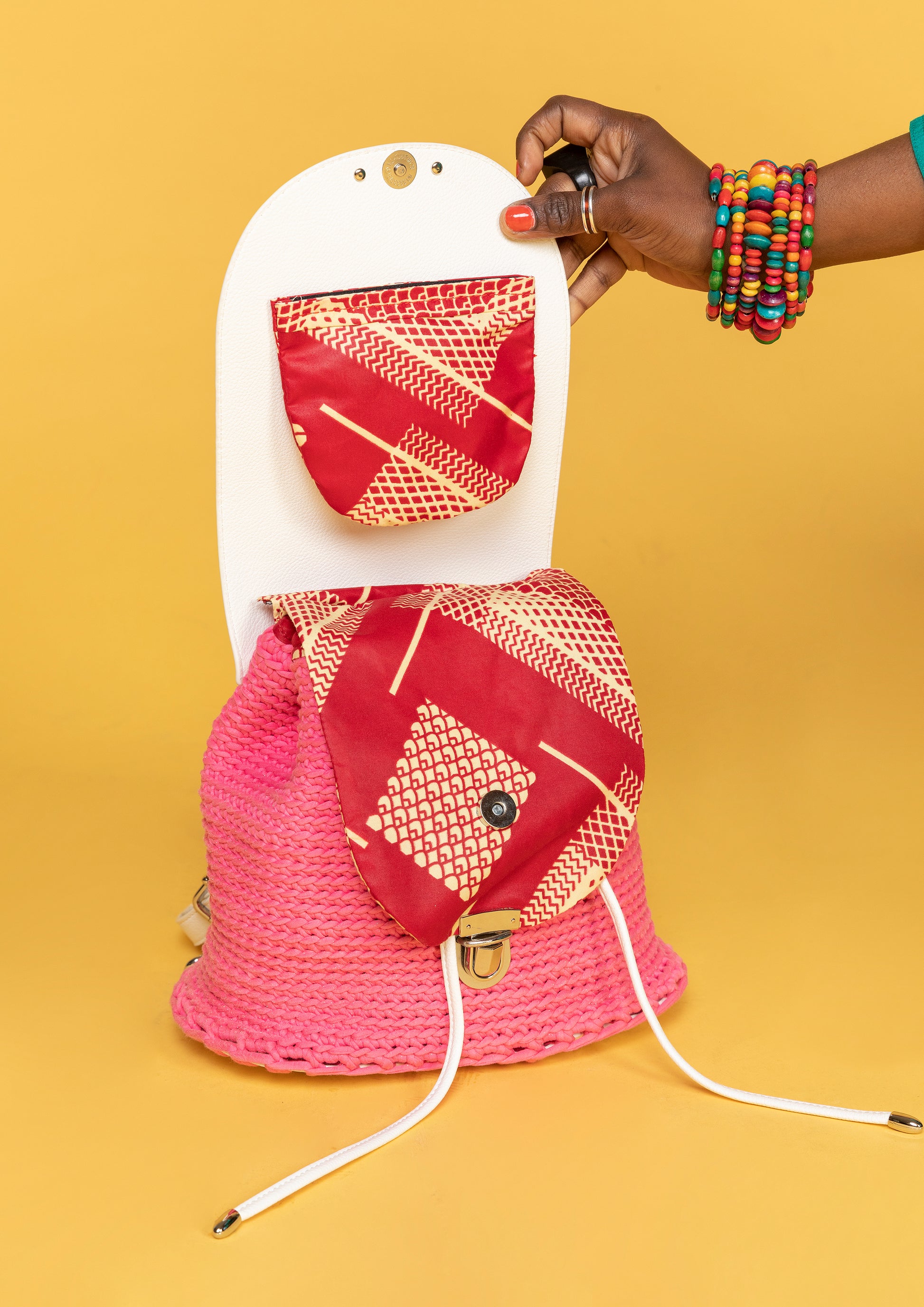 crocheted, pink and white bag, with an African style print, opened and showing part of the interior