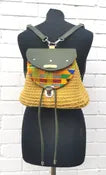 crocheted, golden-yellow and forest green bag, with an African style print. shown on a mannequin, back view. 